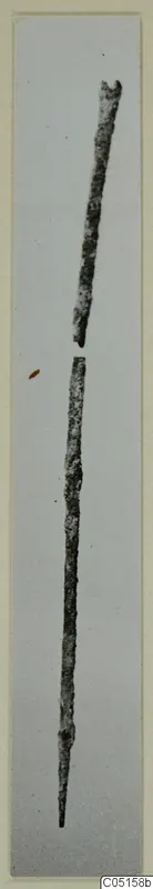 Two corroded bronze tool fragments, long thin rods with one tapering to a point, from Lapithos