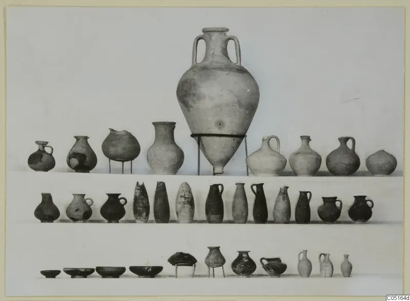 Group of pottery vessels from Kountoura Trachonia, Tomb 10, arranged in three rows against a pale background