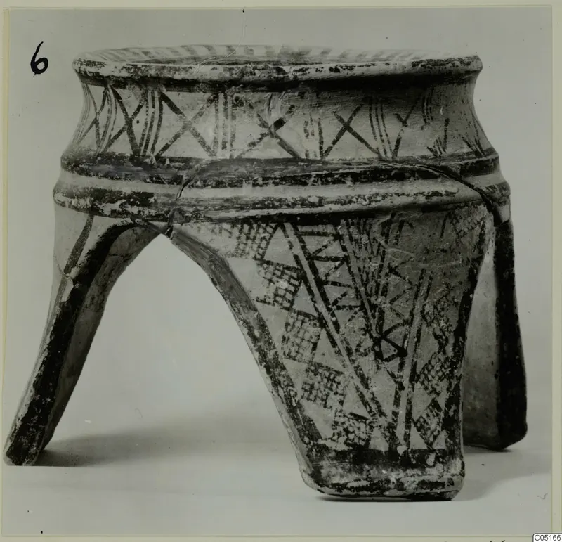 Pottery White Painted I amphora standing on three legs, with dark painted bands and hatched triangles