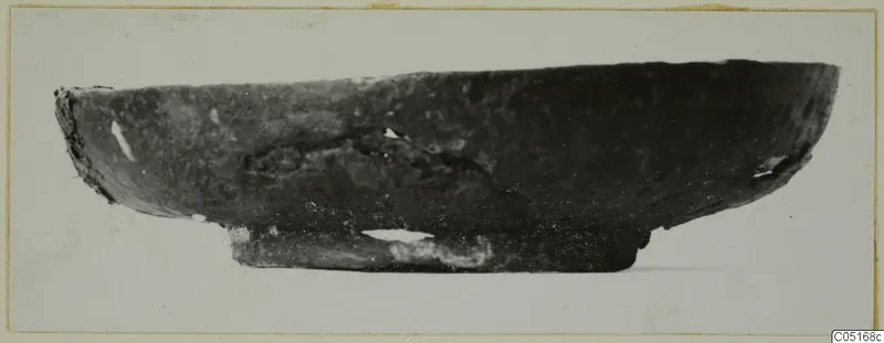 Side view of a dark, shallow bowl with a short foot, from the Kastros tombs at Lapithos