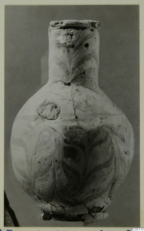 Pot with a tall neck and swirling painted decoration, photographed against a grey backdrop