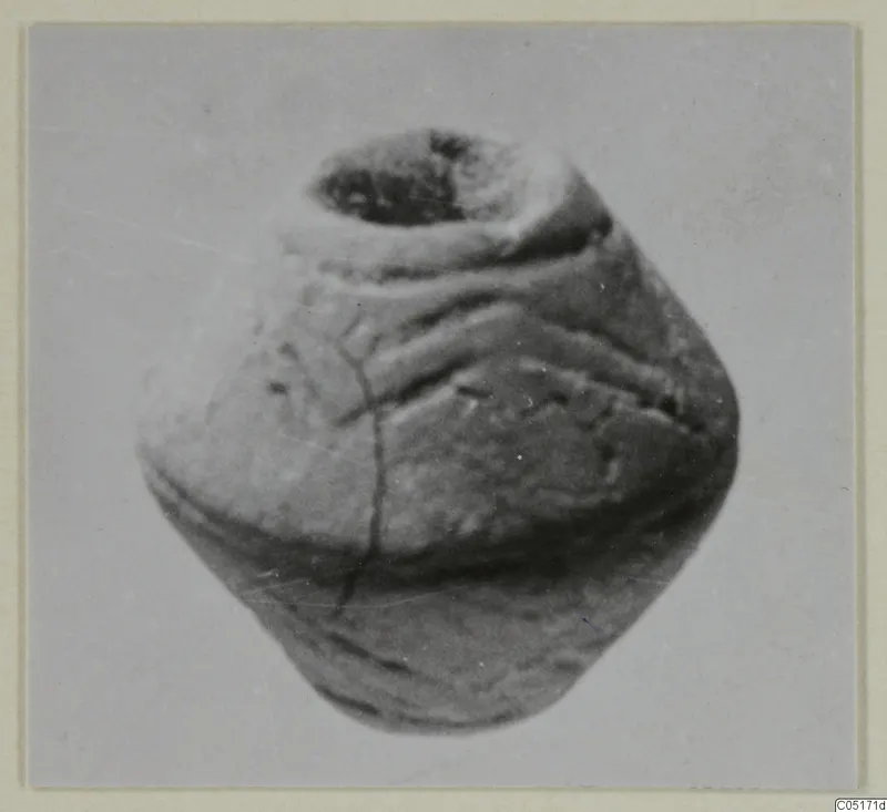 Small rounded object with a wide opening at the top and raised ridges around its body, from Ayios Iakovos.