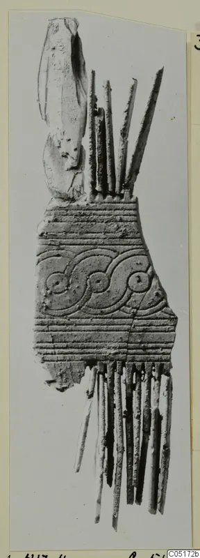 Bone comb from Lapithos, Kastros tombs, with a band of scroll and circle pattern and long teeth
