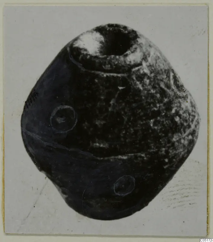 Stone spindle whorl from Lapithos, Kastros tombs, shown alone with a wide hole in its top.