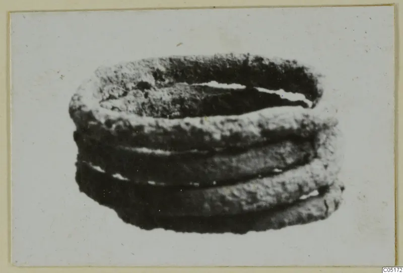 Bronze personal adornment, a coiled band of several turns with a corroded, rough surface