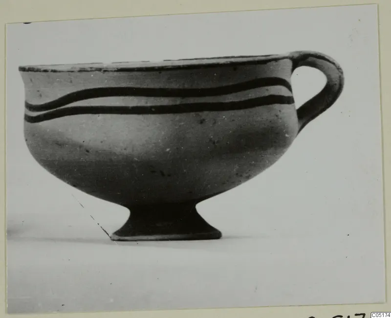 Pottery White Painted I bowl from Lapithos, with a loop handle and two dark horizontal bands on the body