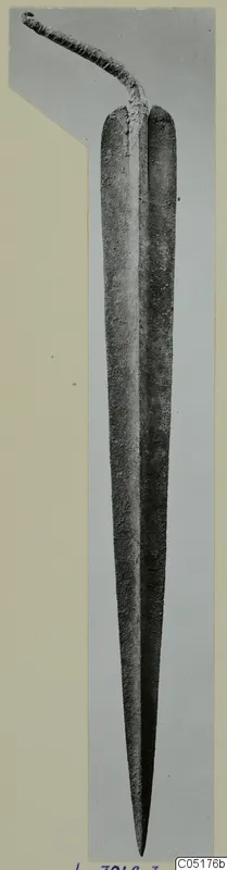 Corroded metal sword with a long tapering blade and a narrow tang, from the Lapithos tombs