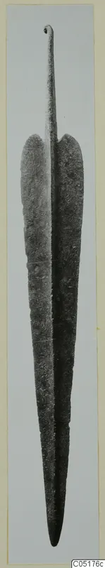 Metal blade from Lapithos, long and leaf-shaped, with a narrow tang ending in a small loop at the top.