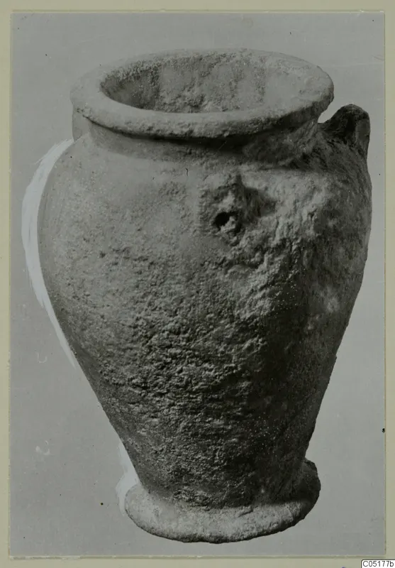 Single-handled vessel with a wide flaring rim and ring base, shown alone against a grey background