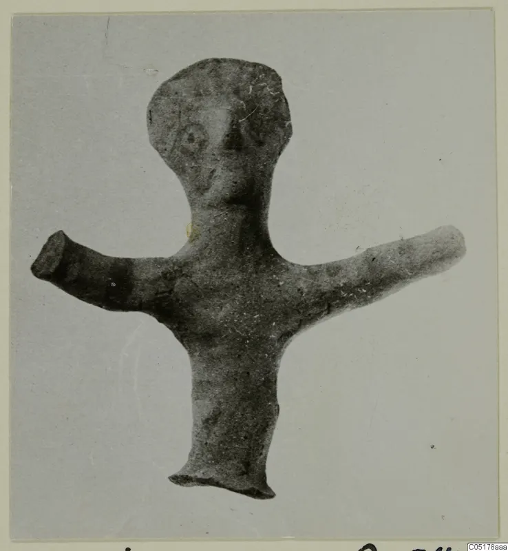 Small terracotta figurine of a standing human figure with outstretched arms and a rounded head.