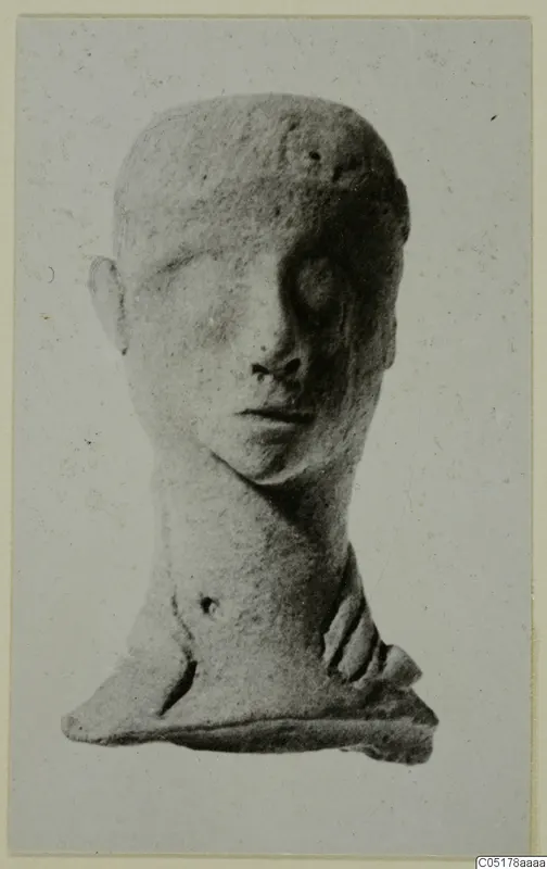 Terracotta head figurine with a long neck and flat base, shown frontally against a pale grey card.