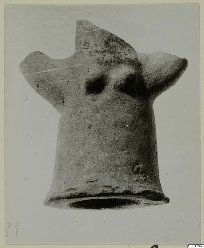 Terracotta Minor Plastic 3 from Ayios Iakovos: hollow clay figure with a flared base and two projections, against grey.