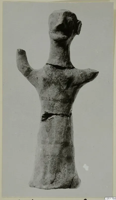 Terracotta figurine of a standing figure with one arm raised, from Ayios Iakovos