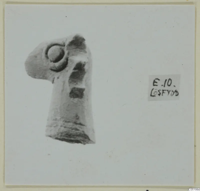 Fragment of a small figurine with a round boss on its upper part, a stray find from Enkomi