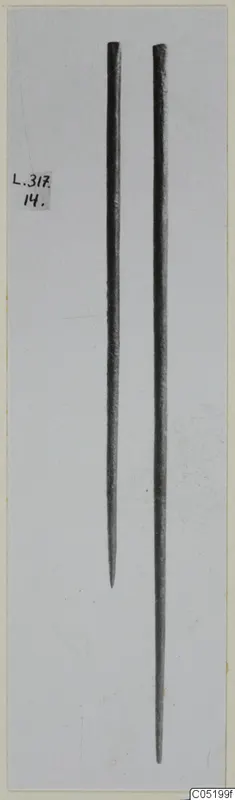 Two pointed bronze tools from Lapithos, shown upright side by side
