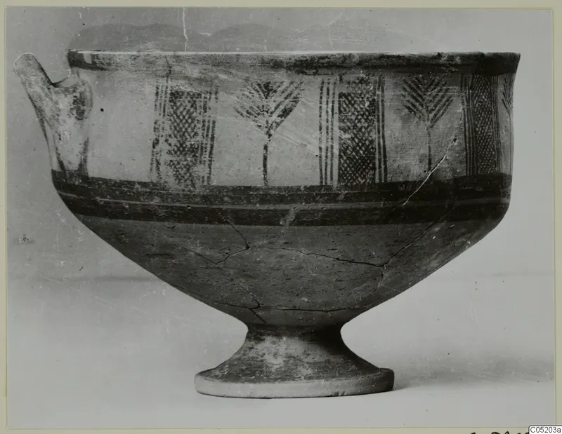 White Painted I bowl with a side handle and vertical panels of painted motifs, photographed against a plain background
