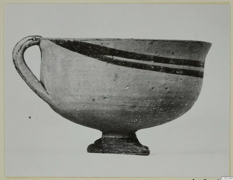 White Painted I bowl with a loop handle and two dark painted bands near the rim