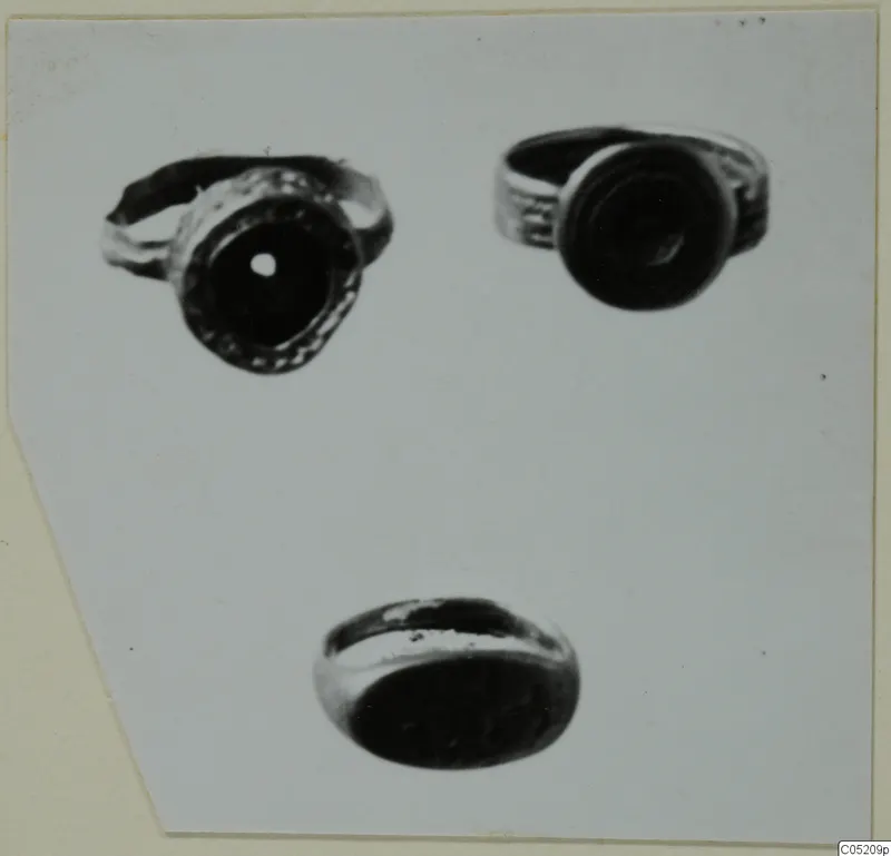 Three finger rings from Enkomi, Tomb 3, photographed from different angles on a pale ground.