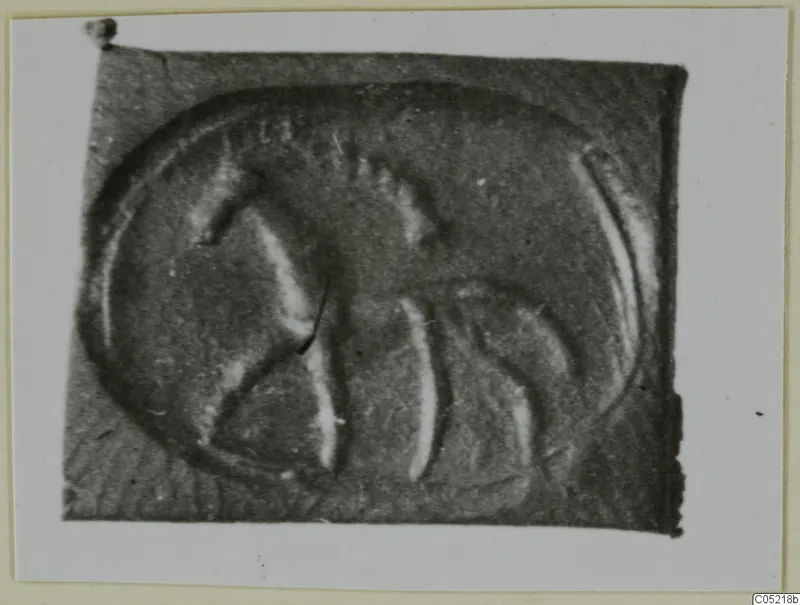 Close view of an engraved seal or gem with a curved design