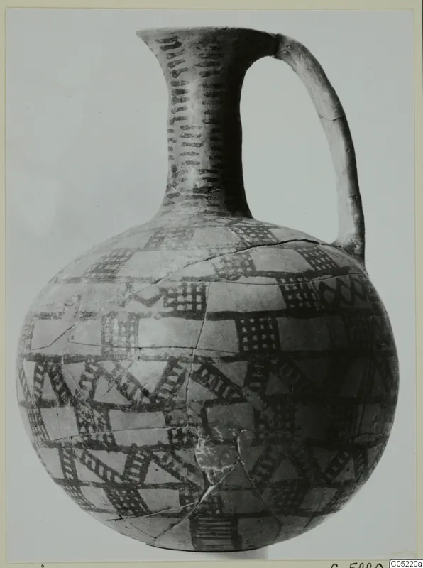 Painted jug with a tall neck, strap handle and dark cross-hatched bands on a pale body, from Ayios Iakovos