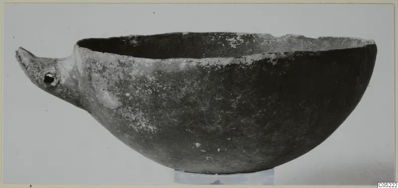 Black slip ware bowl with a beak-like projection at one side, from Ayios Iakovos