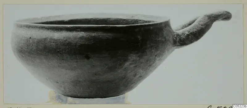 Bowl with a single loop handle, from Enkomi, shown in a side view against a plain light background