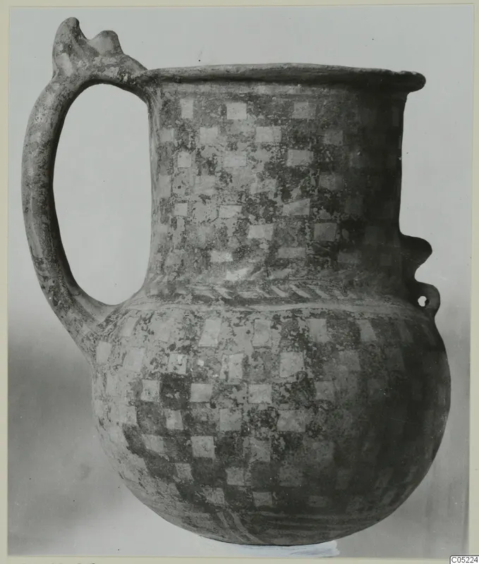 White Painted III-2 tankard with a checkerboard pattern of pale squares and a tall loop handle with a notched top.