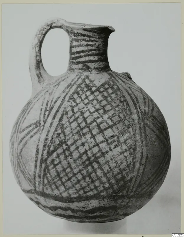White Painted pottery jug with a looped handle and dark painted bands and cross-hatching on a pale body