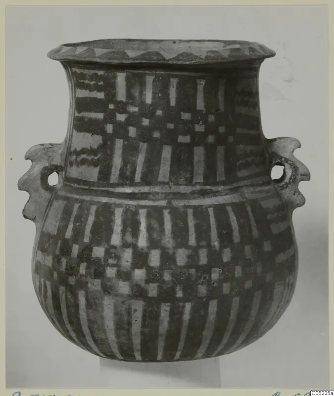 Pottery White Painted III-2 jar with two handles and painted bands, photographed against a pale backdrop