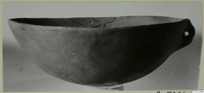 Pottery Red Polished IV bowl with a pierced lug handle, seen from the side, from the Vrysi tou Barba tombs at Lapithos
