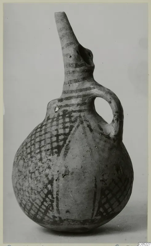 Pottery White Painted III-2 vessel with a tall spout, a single loop handle and a dark painted lattice design