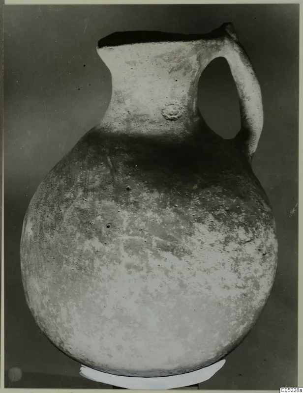 Globular jug with a tall neck and single loop handle, from the Vrysi tou Barba tombs at Lapithos