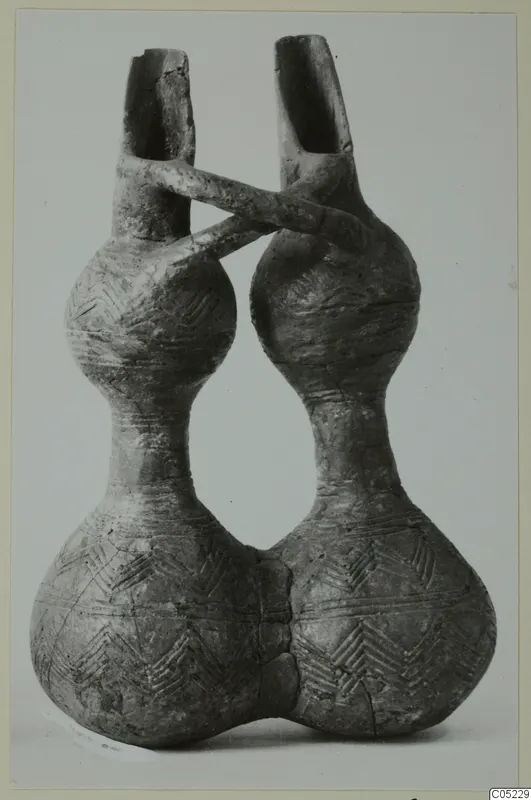 Red Polished III jug with two bulbous bodies, two spouts and a handle crossing between them, incised chevron decoration