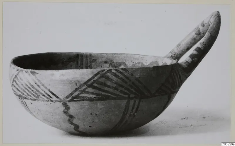 Pottery White Painted III-2 bowl with a long handle and dark painted hatched and zigzag bands