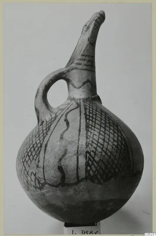 White Painted I - II jug with a beak-shaped spout, a loop handle and dark painted bands and hatching