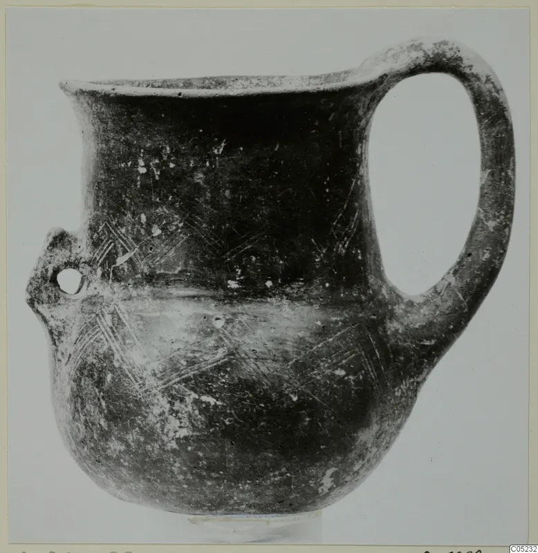 Black Slip Ware jug from Lapithos with a strap handle and incised hatched decoration on the body