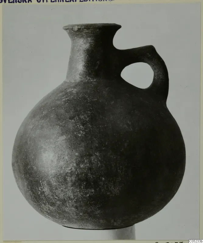 Pottery jug, Red Polished III, with a single loop handle, from the Vrysi tou Barba tombs at Lapithos.