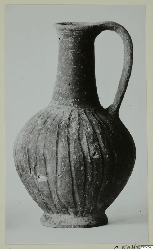 Jug with a tall neck, single loop handle and vertical grooves on the body, from Lapithos