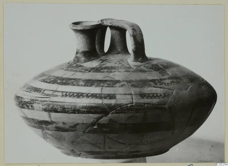 Pottery bowl-jar from Enkomi with two tubular necks, a strap handle and horizontal painted bands