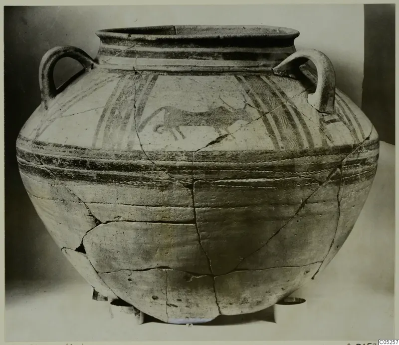 Large bichrome two-handled jar with painted bands and a running animal on the shoulder, shown in a front view.