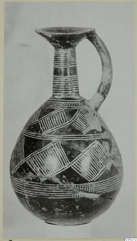 Pottery Red Polished II jug with a single handle, a flared mouth and white painted bands and hatched diagonal patterns