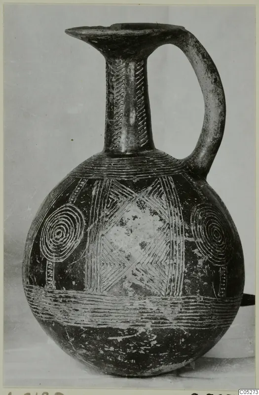 Dark jug with a single loop handle, incised neck bands and concentric circles on the body, from Lapithos