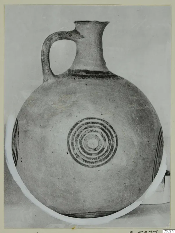 Pottery White Painted I jug with a strap handle and concentric rings on its round body