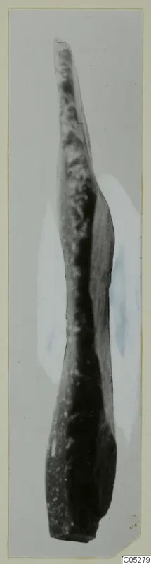 Long narrow stone object tapering to a point at the top, photographed upright at Kythrea