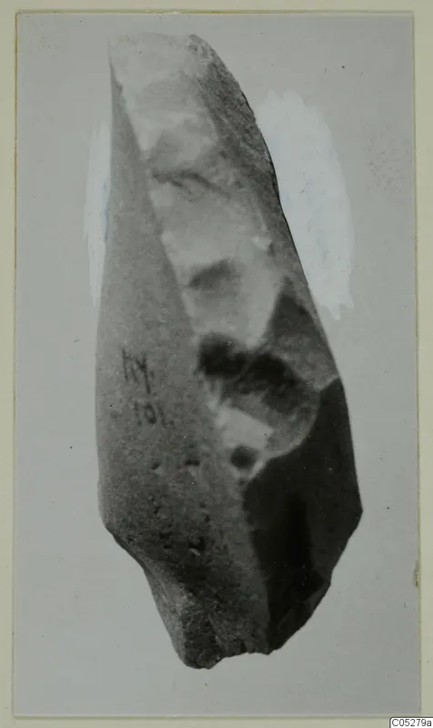 Worked stone object from Kythrea with flaked faces and a handwritten number on its side