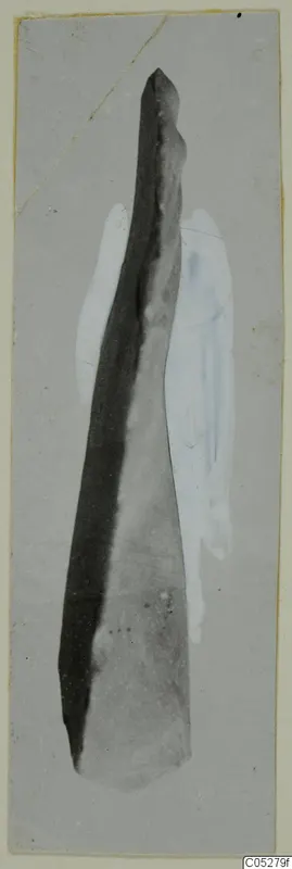Long tapering find with a pointed upper end, photographed on a grey card from Kythrea