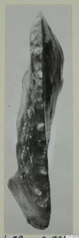 Elongated stone object from Kythrea, tapering to a point at the top, photographed on a pale background