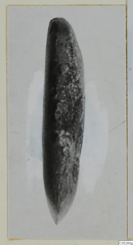 Stone part from Kythrea: an elongated object, rounded at one end and tapering to a point at the other.