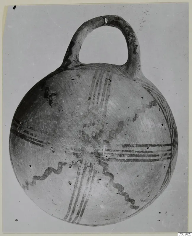 Pottery White Painted III-2 bowl from the Vrysi tou Barba tombs at Lapithos, with a loop handle and dark painted bands