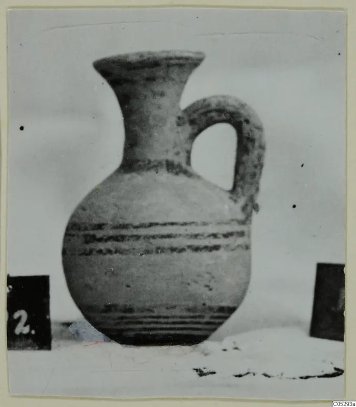 Pottery White Painted II, a jug with a flaring neck, a loop handle and dark painted bands on the body